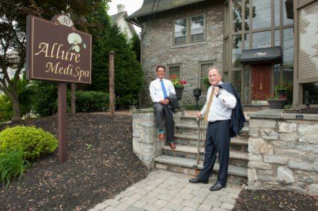 board-certified plastic surgeons Dr. Paul Kim and Dr. Gary Wingate on the steps outside of Legacy Plastic Surgery and Aesthetics